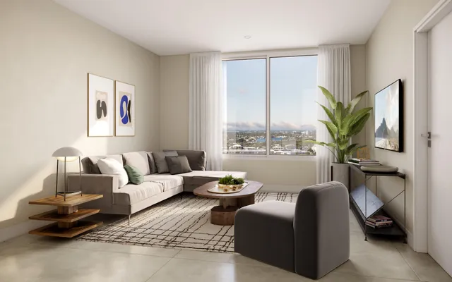 a living room with furniture a lamp and a potted plant