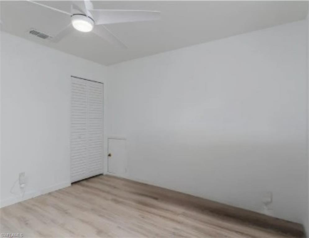 3301 31st Avenue Southwest Naples, FL 34117 - Photo 10 of 22 wooden floor in an empty room