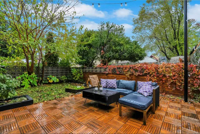 a view of a patio with couches and a table and chairs with garden view