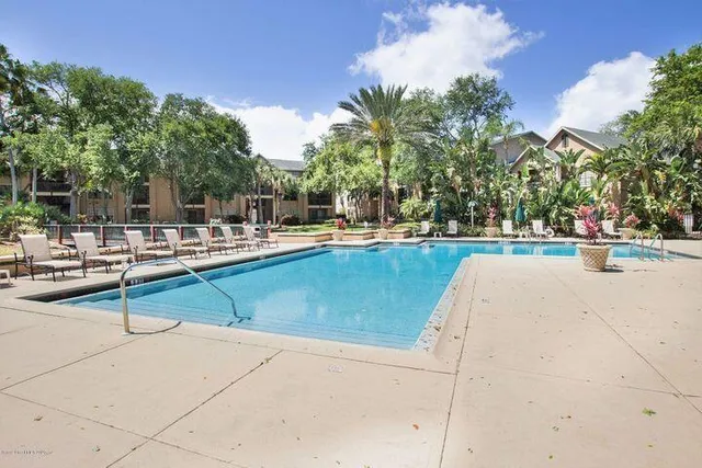 a view of a swimming pool with an outdoor seating