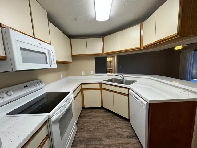 a kitchen with a sink stove and cabinets