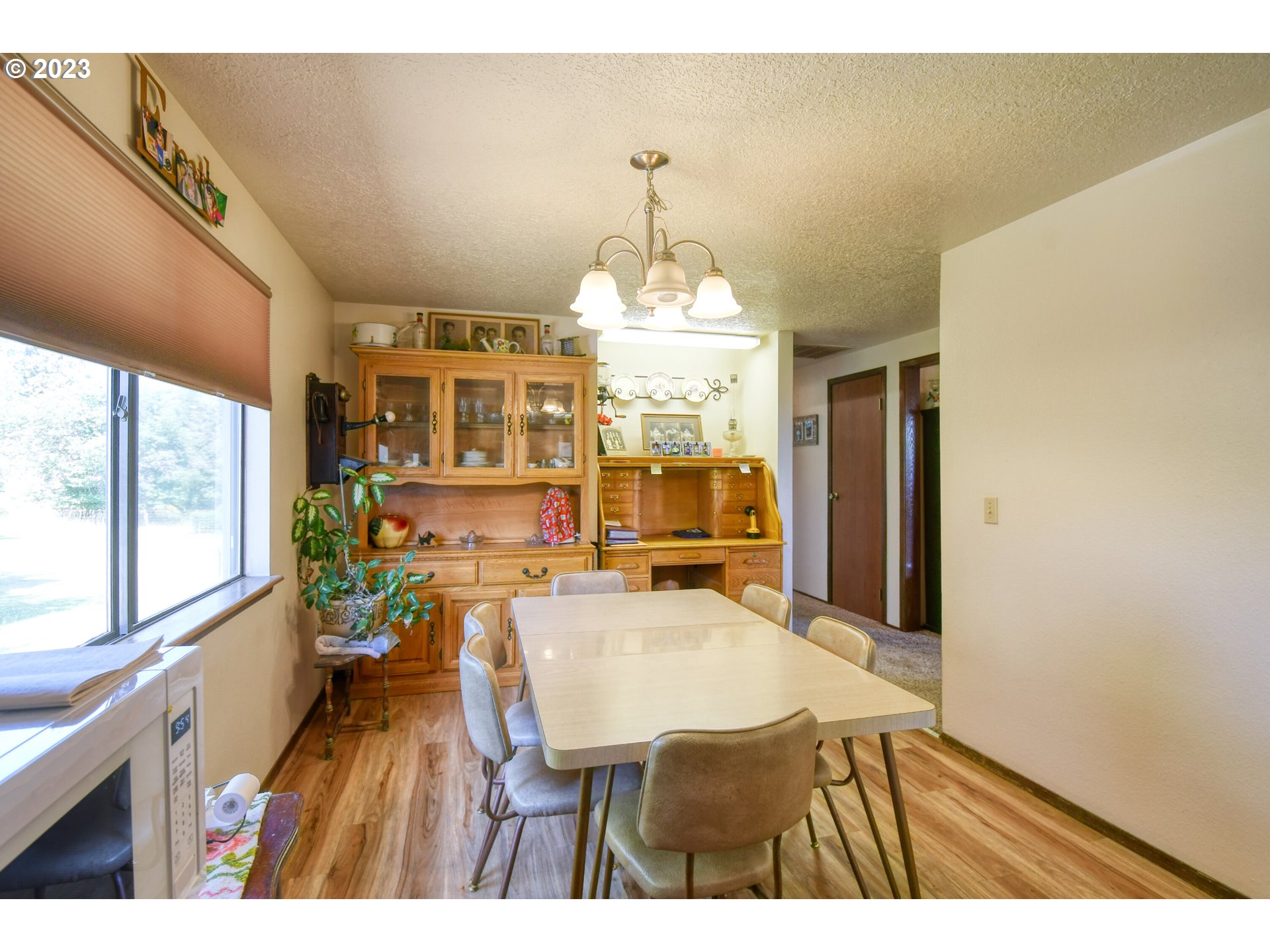 49414 County 1028 Road Pendleton, OR 97801 - Photo 19 of 48 a view of a dining room with furniture a chandelier and wooden floor