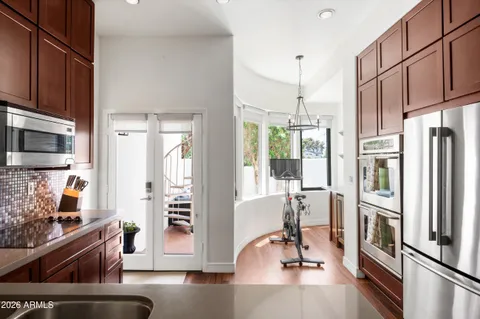 a view of a kitchen with refrigerator and windows