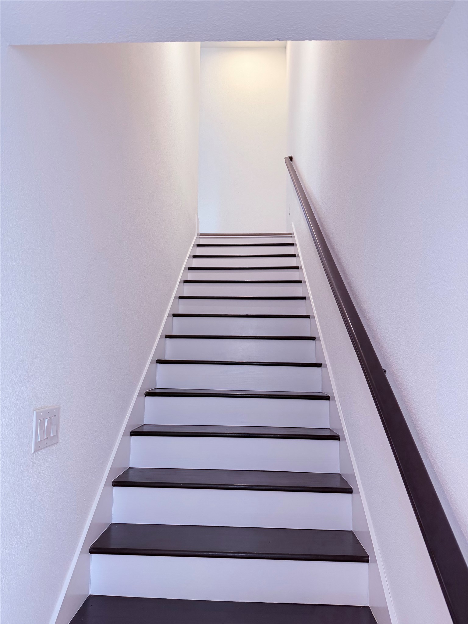 1417 Kramer Lane, Unit 7 Austin, TX 78758 - Photo 23 of 24 Boldly contrasting dark treads and light risers create a striking ascent within this residence.
