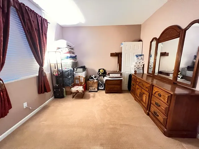 a bed room with furniture and a flat screen tv