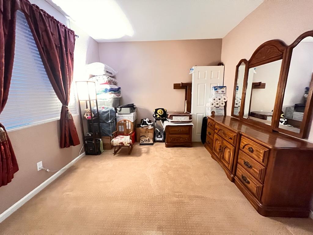 484 Presidio Place Tracy, CA 95377 - Photo 13 of 40 a bed room with furniture and a flat screen tv