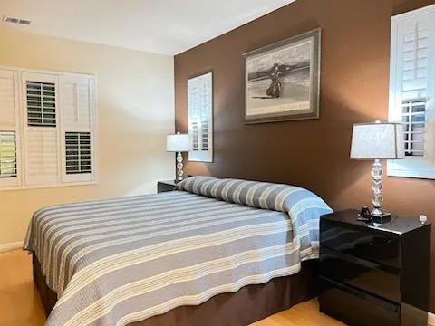 a bedroom with bed and a window