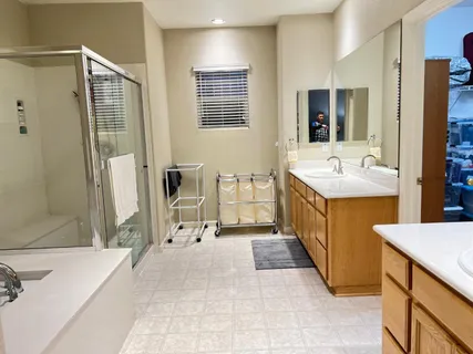 a bathroom with a tub sink and mirror