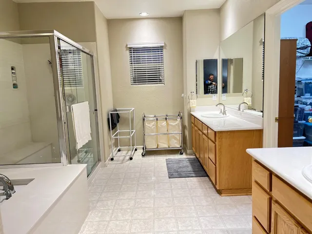 a bathroom with a tub sink and mirror