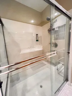 a bathroom with a shower and a bath tub