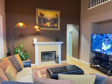 a living room with furniture and a fireplace