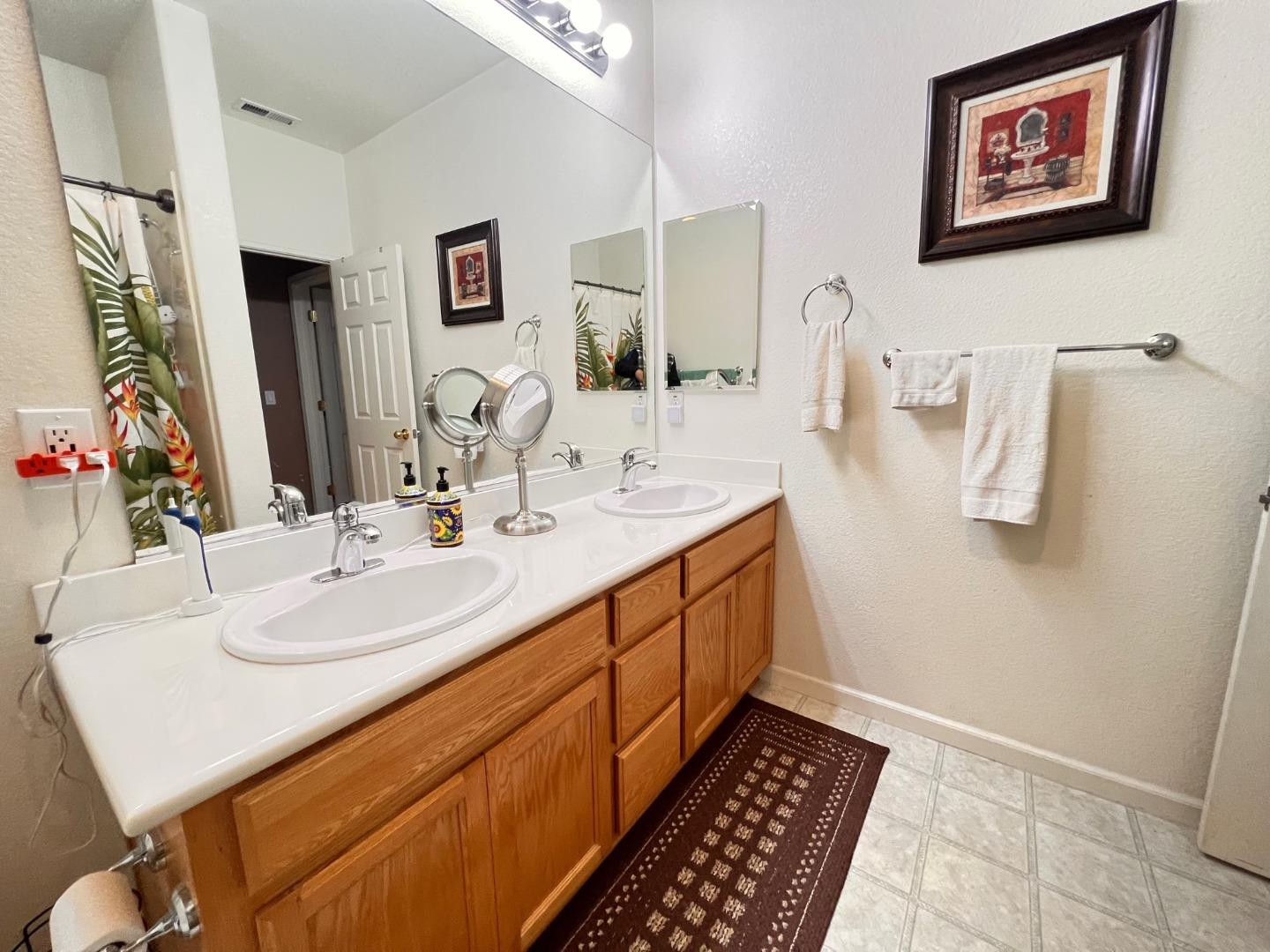 484 Presidio Place Tracy, CA 95377 - Photo 30 of 40 a bathroom with a double vanity sink and a mirror