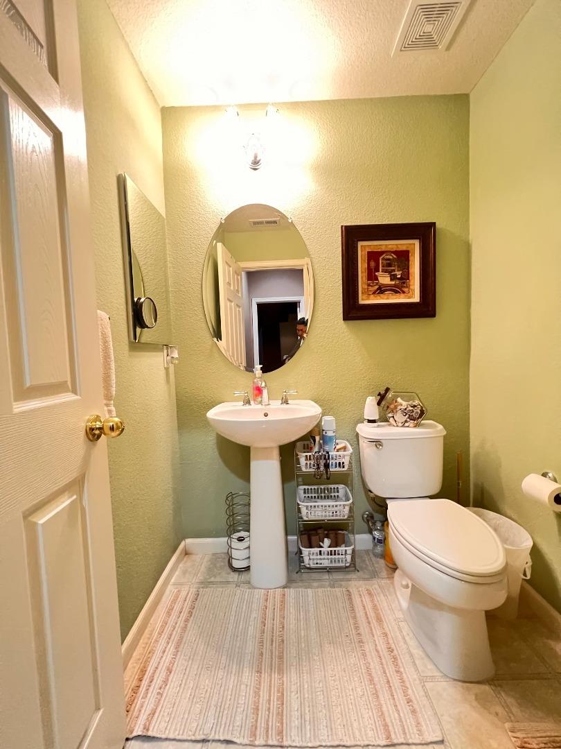 484 Presidio Place Tracy, CA 95377 - Photo 33 of 40 a bathroom with a sink toilet and mirror