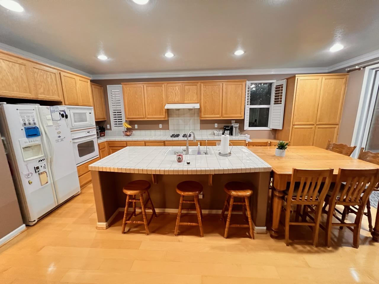 484 Presidio Place Tracy, CA 95377 - Photo 7 of 40 a dinning table and chairs in a kitchen