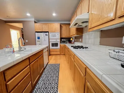 a kitchen with stainless steel appliances kitchen island granite countertop a sink and cabinets