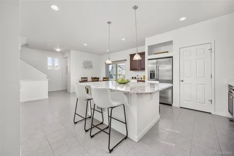 a kitchen with stainless steel appliances kitchen island granite countertop a sink and cabinets
