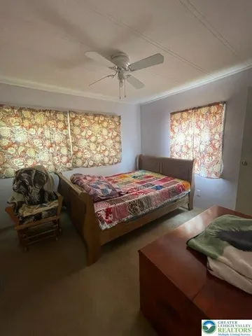 a bedroom with a bed and a night stand