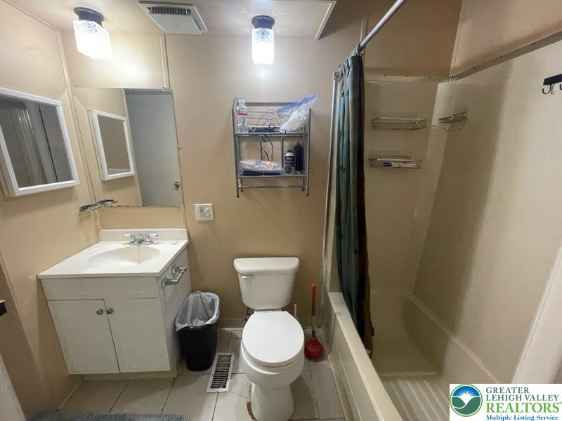 10 Springridge Road Bath, PA 18014 - Photo 12 of 20 a bathroom with a toilet sink and mirror