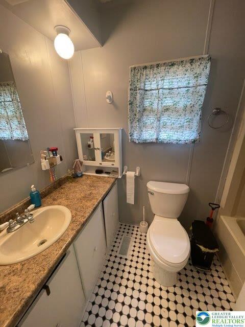 10 Springridge Road Bath, PA 18014 - Photo 13 of 20 a bathroom with a granite countertop toilet a sink and a mirror