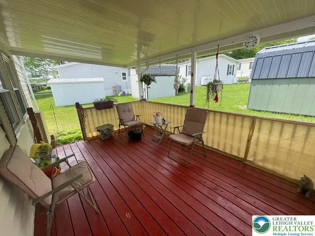 a view of deck with table and chairs with wooden floor