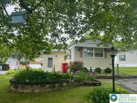 a front view of house with yard and green space