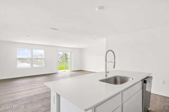 a kitchen with a sink a counter and a window