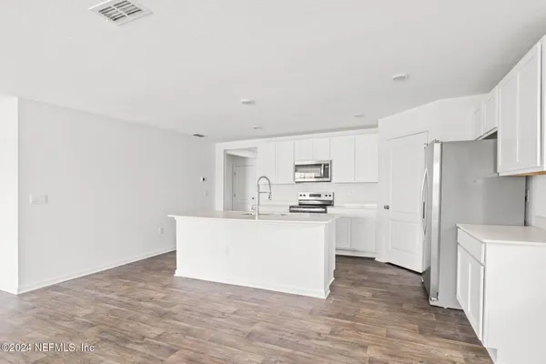 a kitchen with stainless steel appliances a sink and a refrigerator