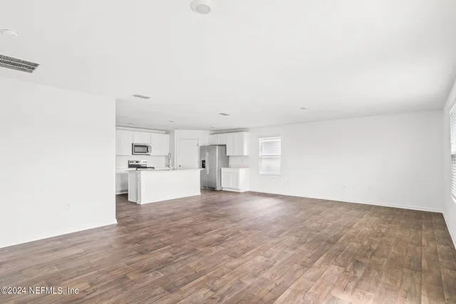a view of a kitchen with wooden floor
