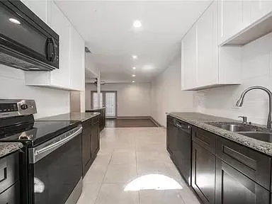 a kitchen that has a sink and a stove