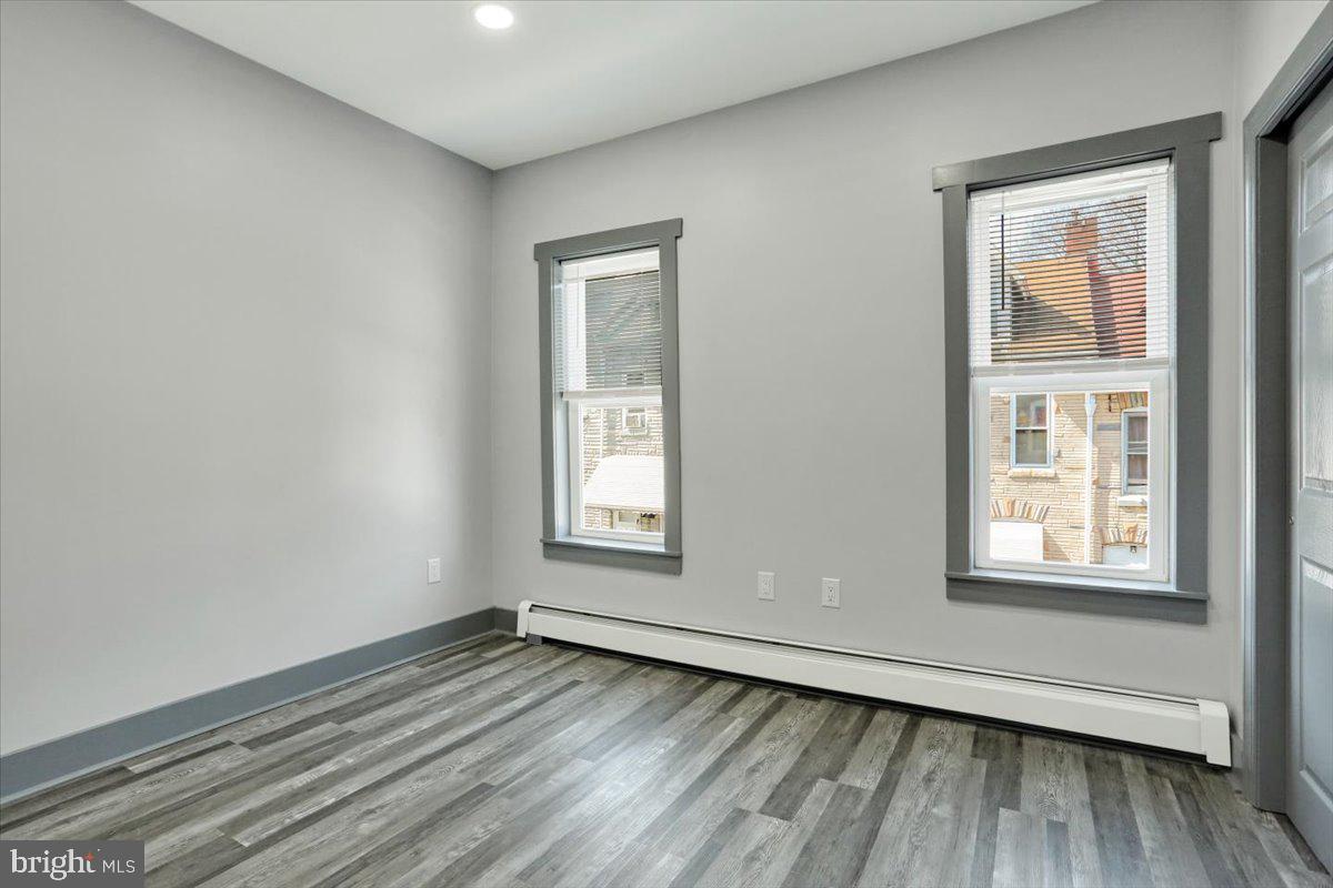 553 Wunder Street, Unit 2 Reading, PA 19602 - Photo 12 of 20 an empty room with wooden floor and windows
