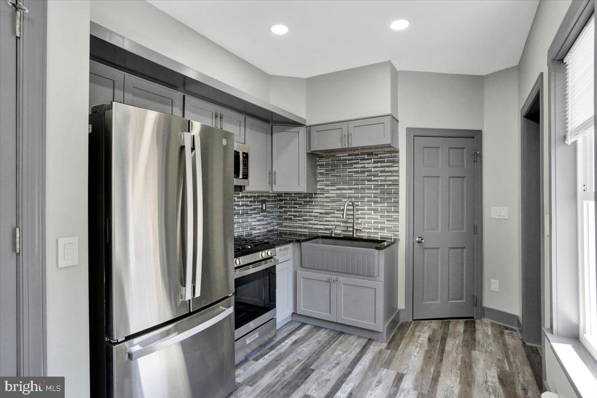 553 Wunder Street, Unit 2 Reading, PA 19602 - Photo 4 of 20 a kitchen with stainless steel appliances granite countertop a refrigerator and a sink