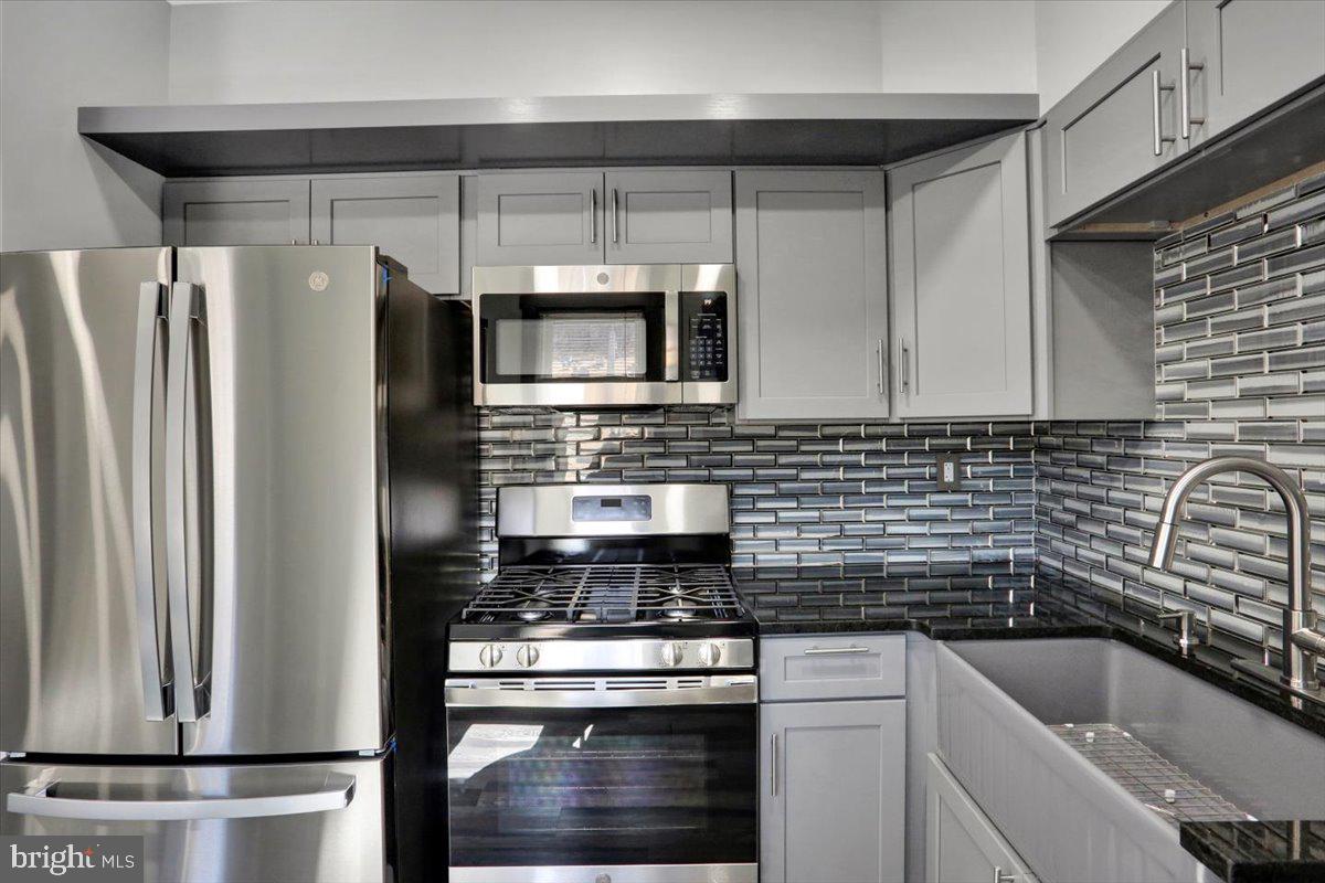 553 Wunder Street, Unit 2 Reading, PA 19602 - Photo 5 of 20 a kitchen with stainless steel appliances a sink stove and refrigerator