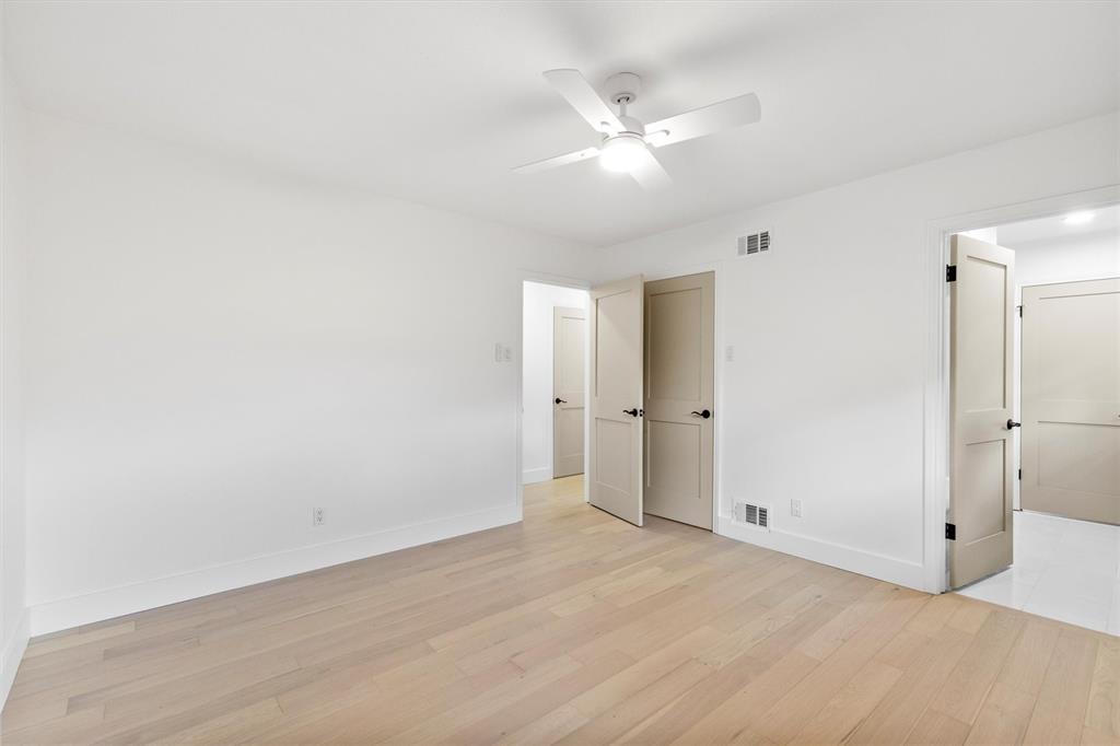 4446 Thunder Road Dallas, TX 75244 - Photo 19 of 30 Spacious room with light wood-finish flooring, white walls, and white baseboards