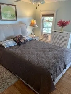 a bedroom with a bed and a window