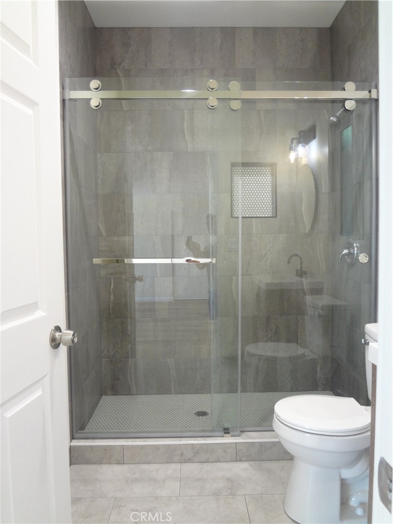 1717 2nd Street San Fernando, CA 91340 - Photo 18 of 18 a bathroom with a shower and a toilet