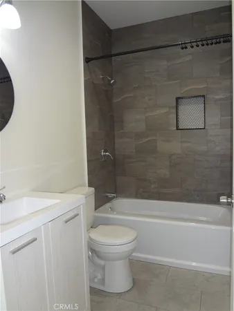 a bathroom with a toilet sink and shower
