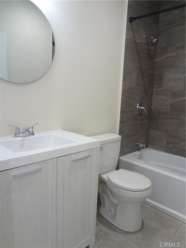 1717 2nd Street San Fernando, CA 91340 - Photo 10 of 18 a bathroom with a sink a toilet and a mirror