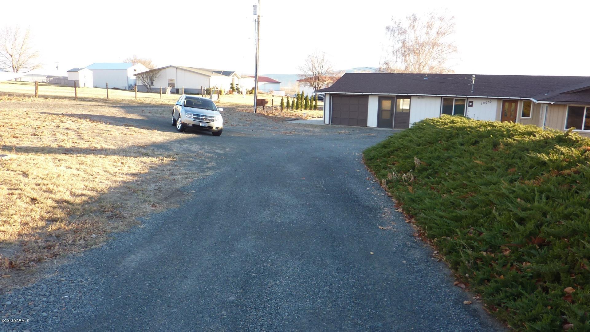 10030 Mieras Road Yakima, WA 98901 - Photo 3 of 23 a view of multiple house with outdoor space and parking