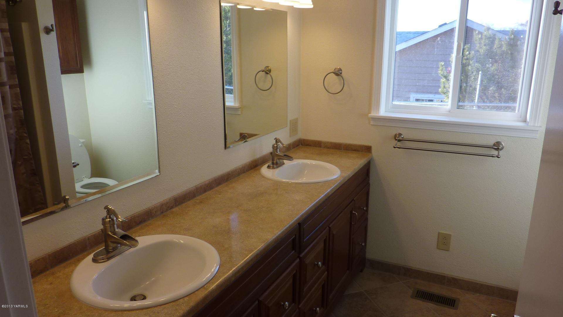 10030 Mieras Road Yakima, WA 98901 - Photo 6 of 23 a bathroom with a sink and a mirror