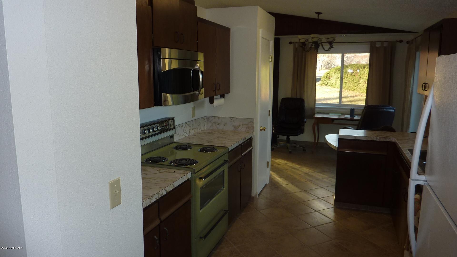10030 Mieras Road Yakima, WA 98901 - Photo 9 of 23 a kitchen with a stove and a microwave