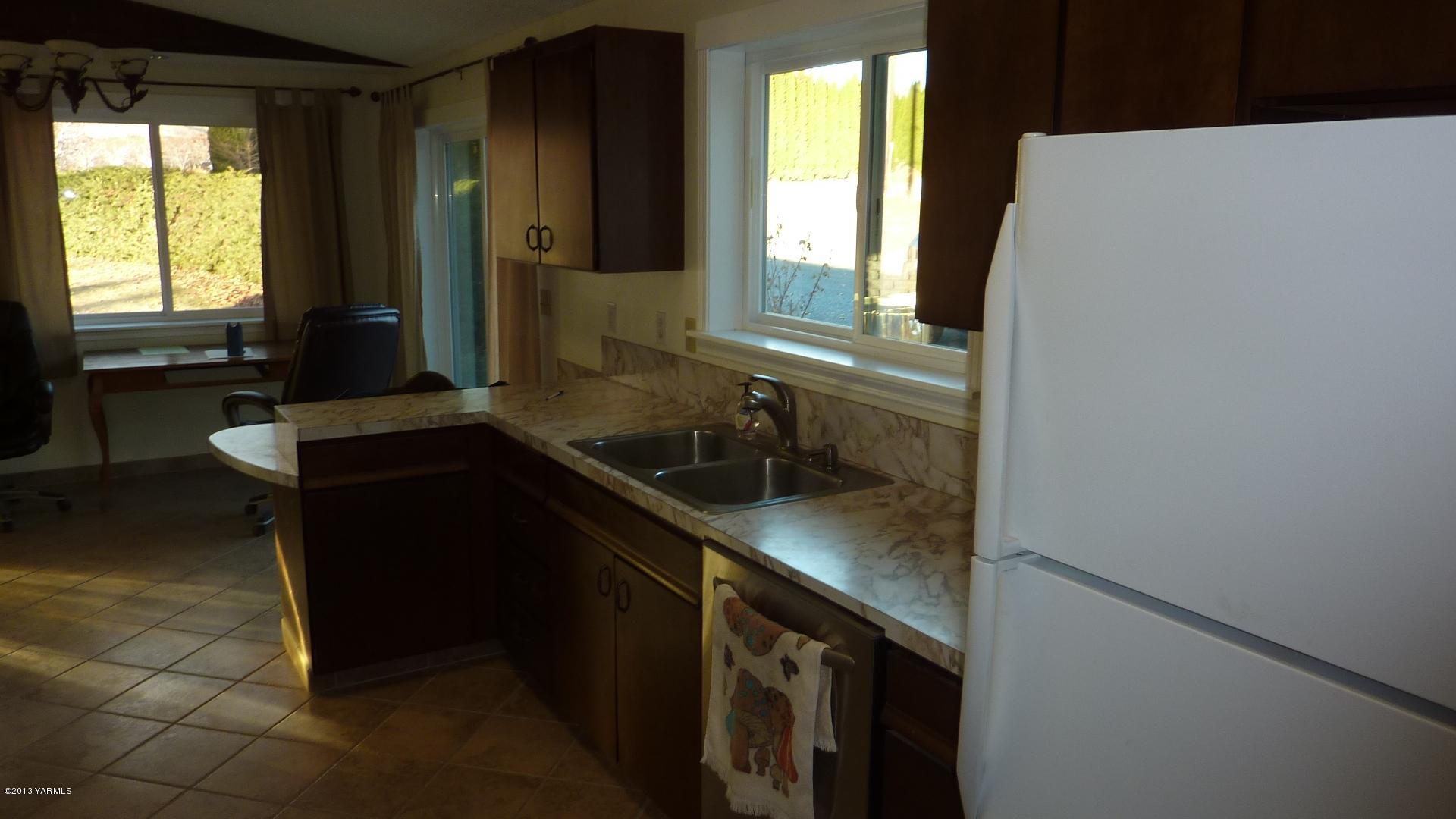 10030 Mieras Road Yakima, WA 98901 - Photo 10 of 23 a kitchen with a sink and a window