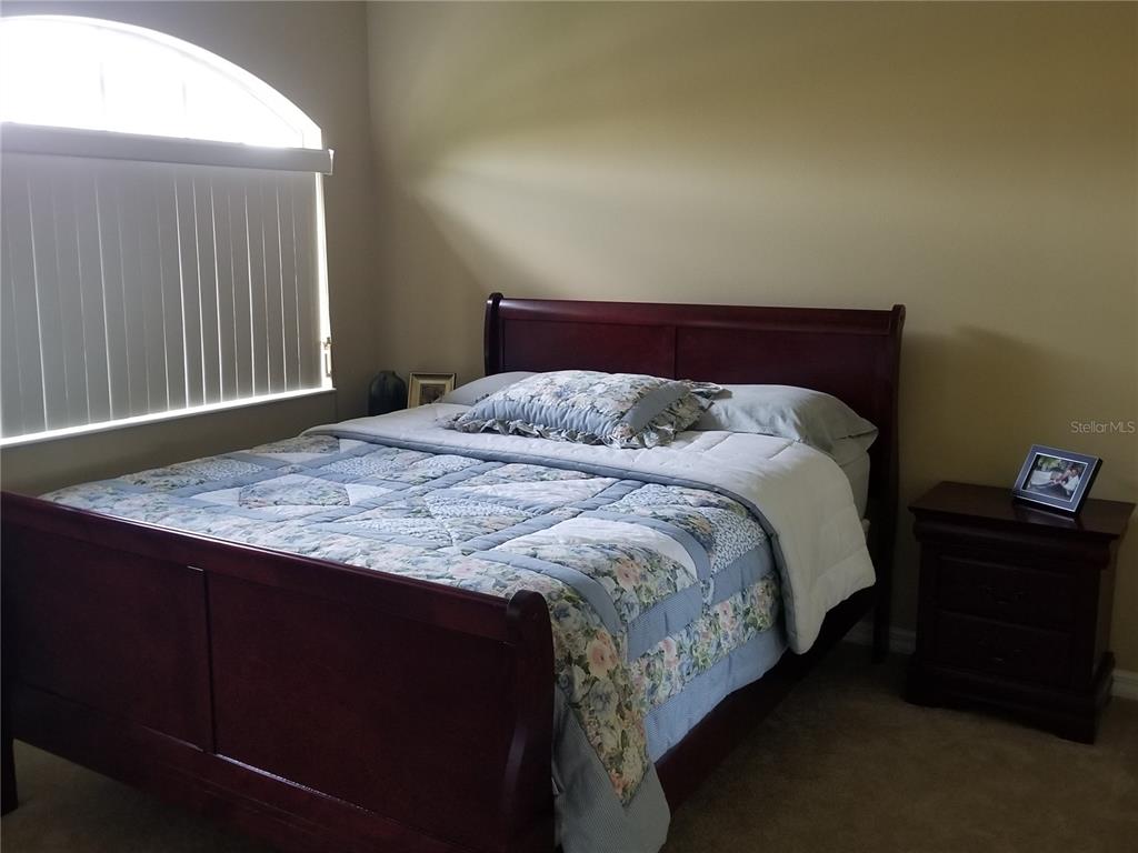 6380 Rookery Circle Bradenton, FL 34203 - Photo 11 of 22 a bed sitting in a bedroom next to a window