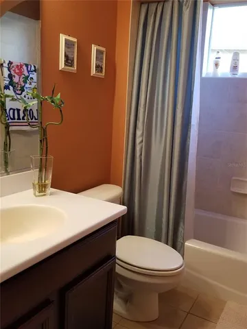 a bathroom with a sink a toilet a mirror and shower