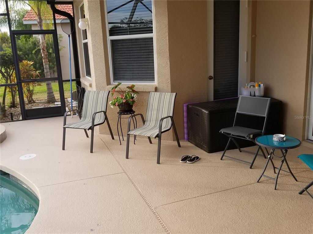 6380 Rookery Circle Bradenton, FL 34203 - Photo 16 of 22 a view of a patio with table and chairs and potted plants
