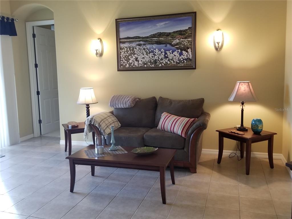 6380 Rookery Circle Bradenton, FL 34203 - Photo 2 of 22 a living room with furniture a lamp and a window