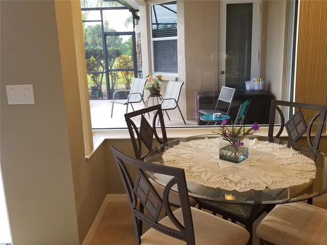 a view of a dining room with furniture and window