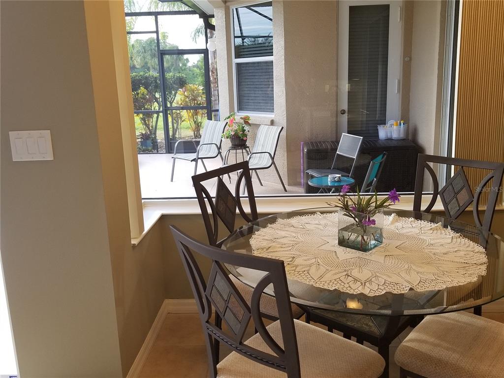 6380 Rookery Circle Bradenton, FL 34203 - Photo 5 of 22 a view of a dining room with furniture and window