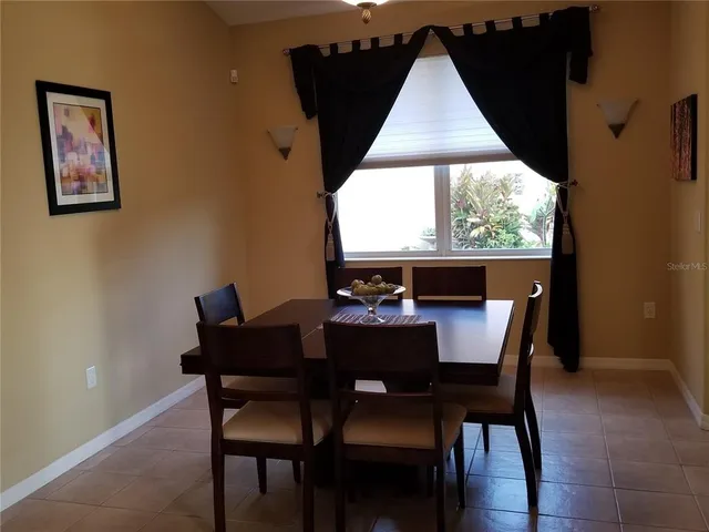 a dining room with furniture and window