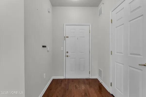 a view of room with wooden floor