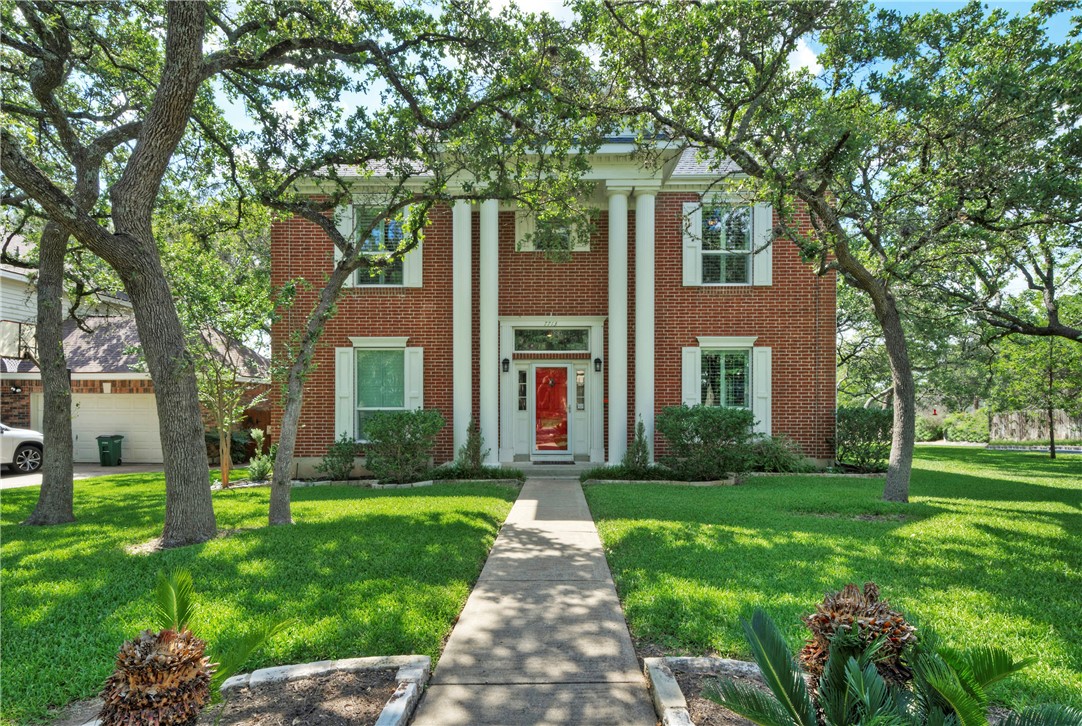 a front view of house with yard and green space